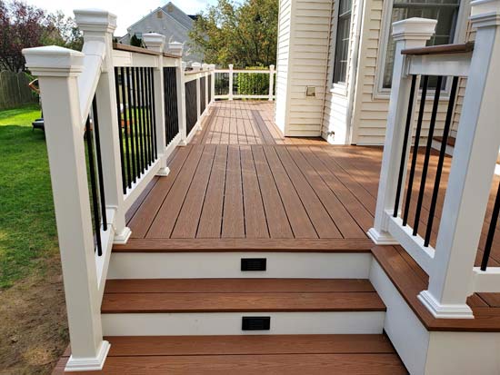 Brown composite deck with white railings and black balusters