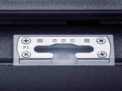 Close-up of metal latch plate with screws