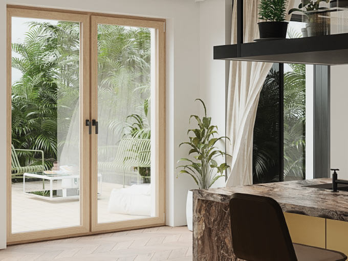 Modern kitchen overlooking lush tropical patio through glass doors