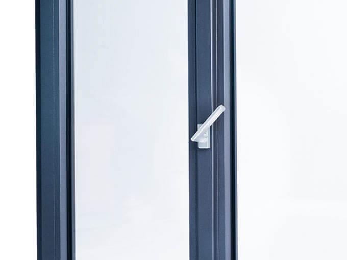 Close-up of modern dark-framed window with silver handle