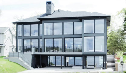 Modern black-framed glass house with elevated deck